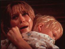 Susan George tries to protect the child in FRIGHT.