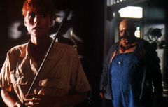 A fat zombie creeps up on Patricia Tallman in Savin's film...