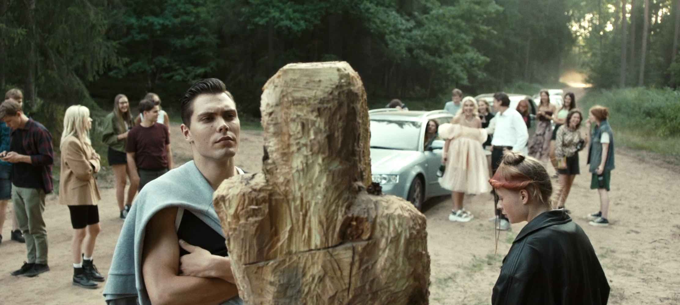 Partying teens find a strange wooden statue, but ignore the omen in Lithuanian slasher movie PENSIVE